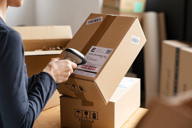 A Person Scanning A Box